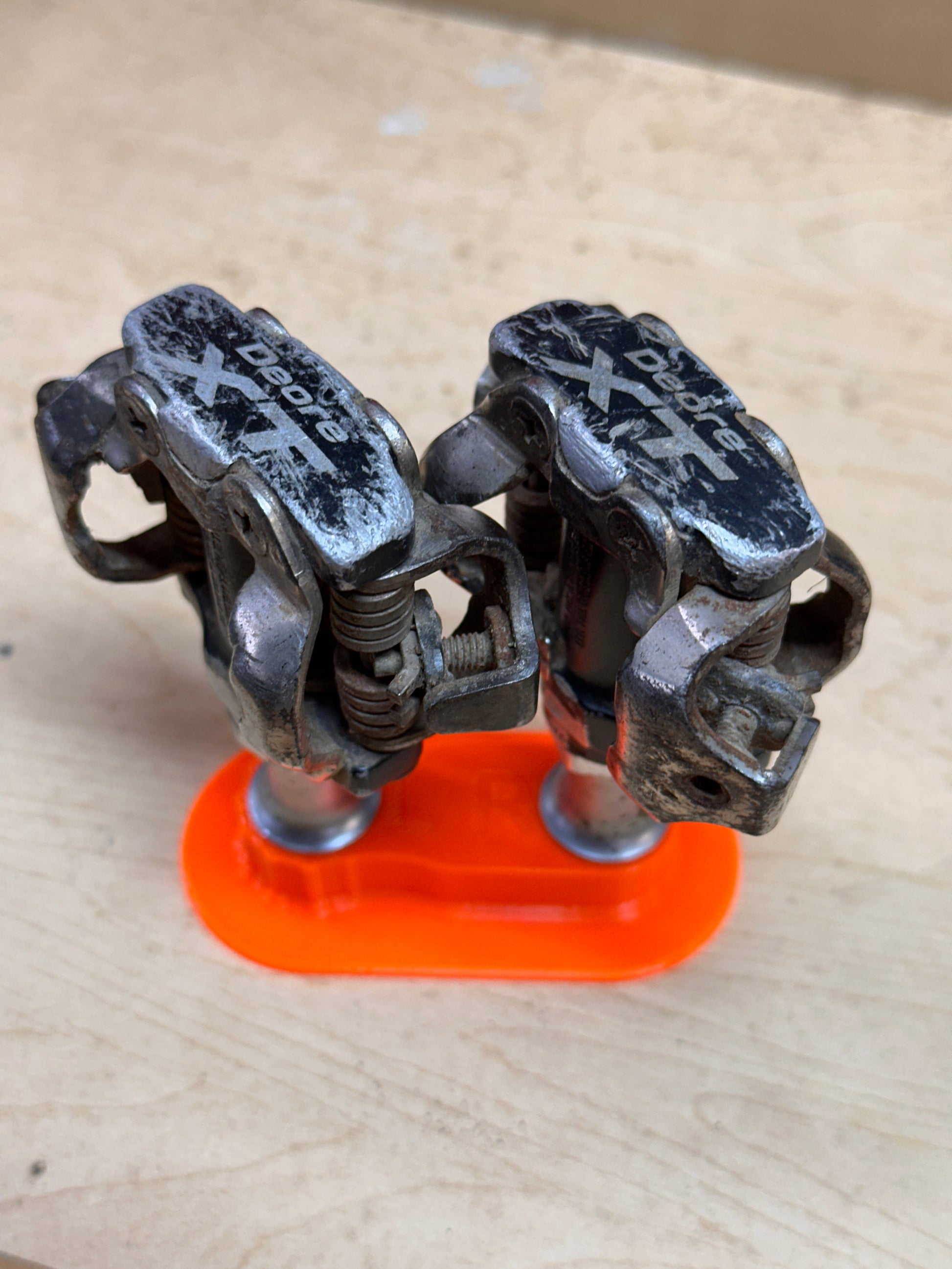 Clipless pedals standing upright in wide base parallel holder